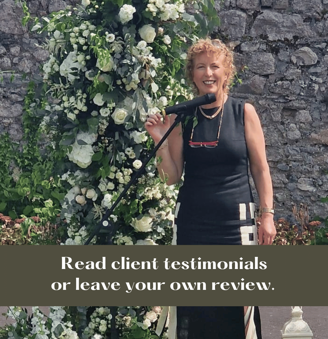 Wedding Celebrant Aine standing before a beautiful flower display