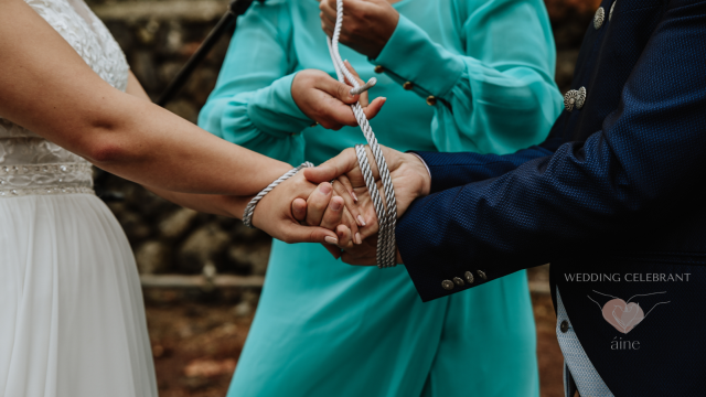 Irish handfasting ceremony with couple’s hands bound by a celebrant using a white rope